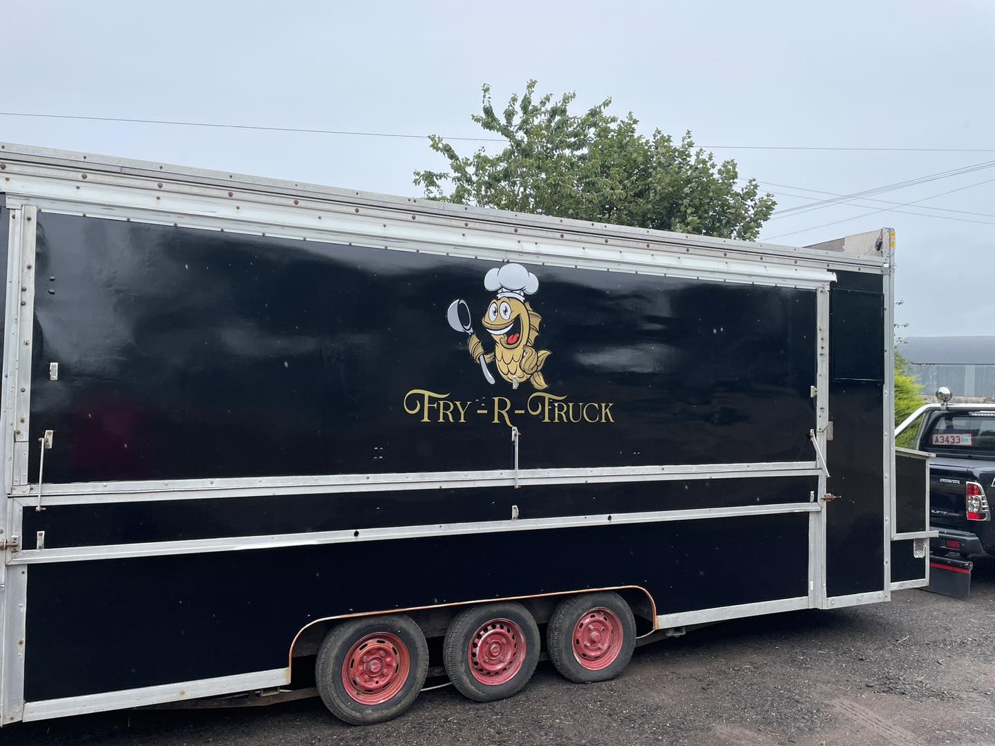 fry truck black with fish logo